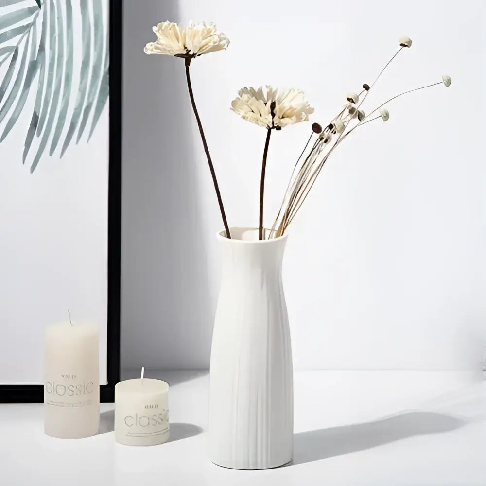White ceramic nordic plastic vase with vertical ridged texture holding dried flowers for modern home decor