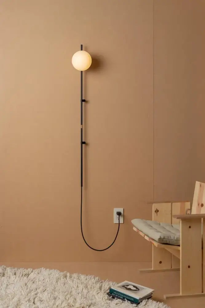 Decorbites™ nordic plug in wall lamp sconce with sleek black metal frame and warm glowing spherical bulb lamp sconce