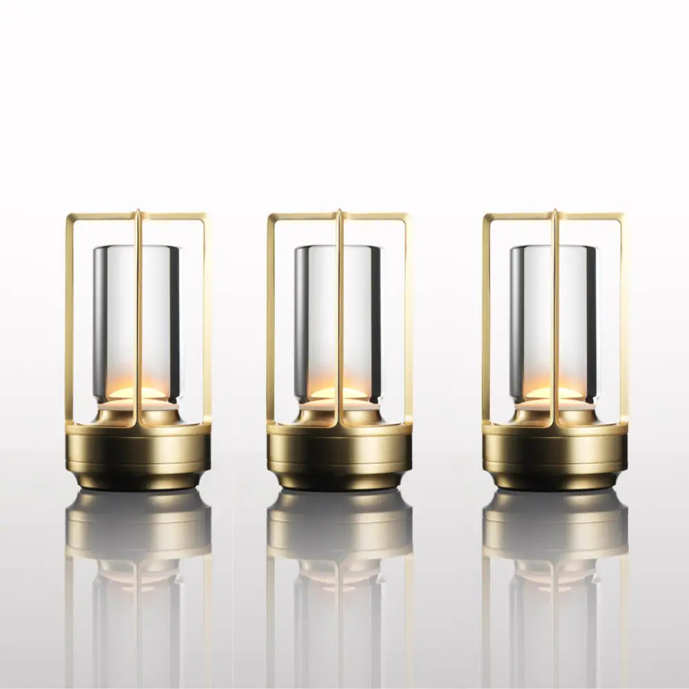 Three elegant brass-framed decorbites nordic rechargeable table lamps with clear glass and warm internal lighting