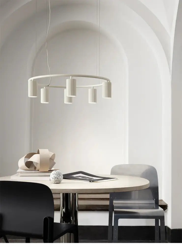 Minimalist white ceramic decorbites™ nordic rotatable donna circle chandelier with cylindrical fixtures above dining table