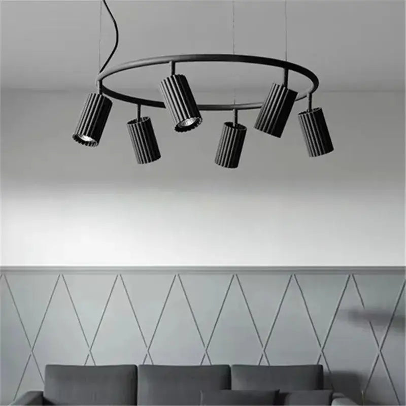 Black circular DecorBites™ Nordic rotatable circle chandelier with five ribbed cylindrical fixtures for dining and kitchen