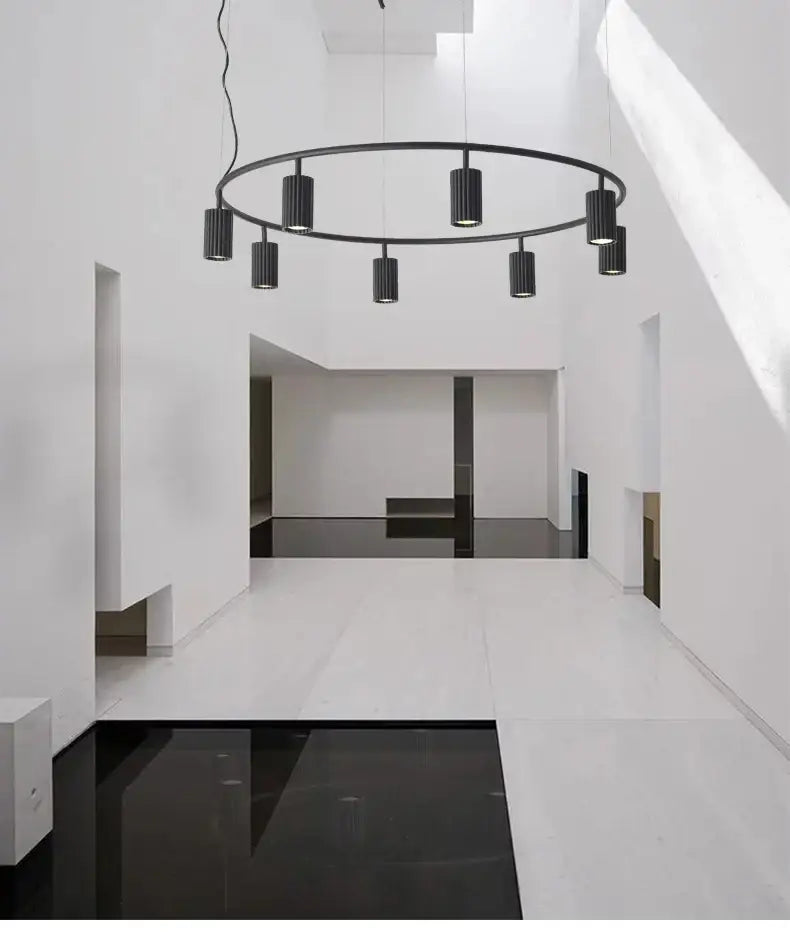 Black circular pendant light with cylindrical bulbs suspended from thin cords for dining and kitchen use by decorbites nordic rotatable donna circle chandelier