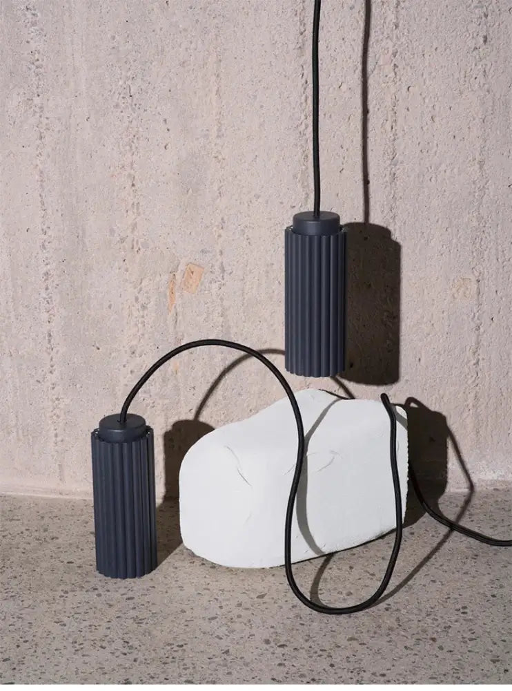 Dark gray ribbed cylindrical pendant lamps with black cords featured in decorbites™ nordic rotatable donna circle chandelier