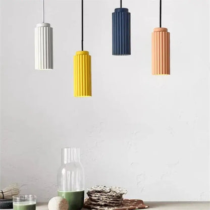 Four modern cylindrical pendant lights in white yellow navy blue and terracotta on decorbites nordic donna circle chandelier
