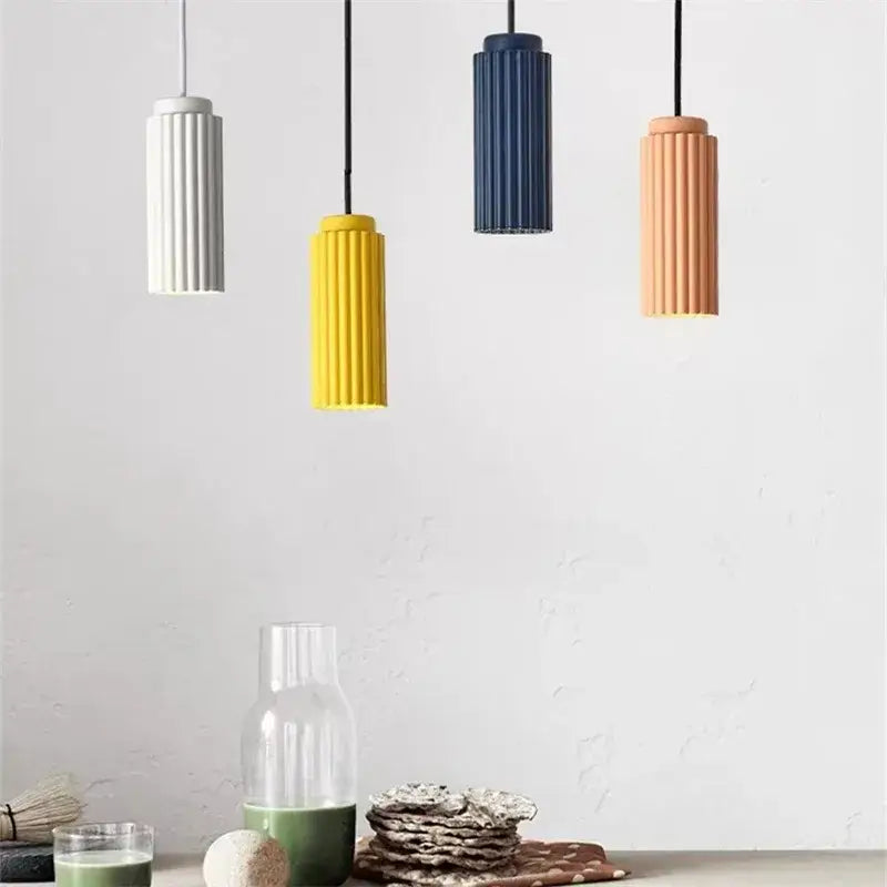 Four modern cylindrical pendant lights in white yellow navy blue and terracotta on decorbites nordic donna circle chandelier