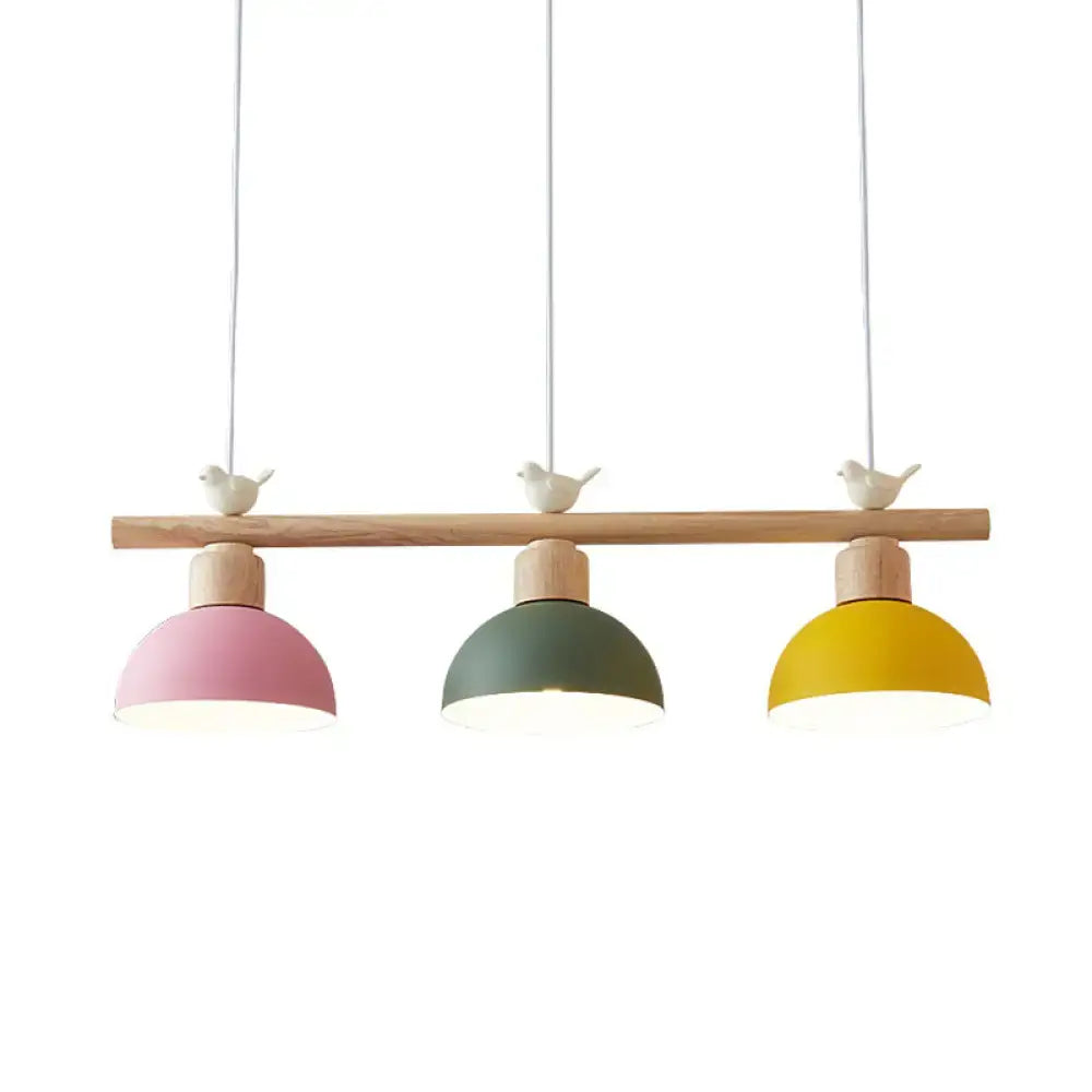 Pastel-colored DecorBites Nordic hanging island light with three metal dome shades and bird decor on wooden bar