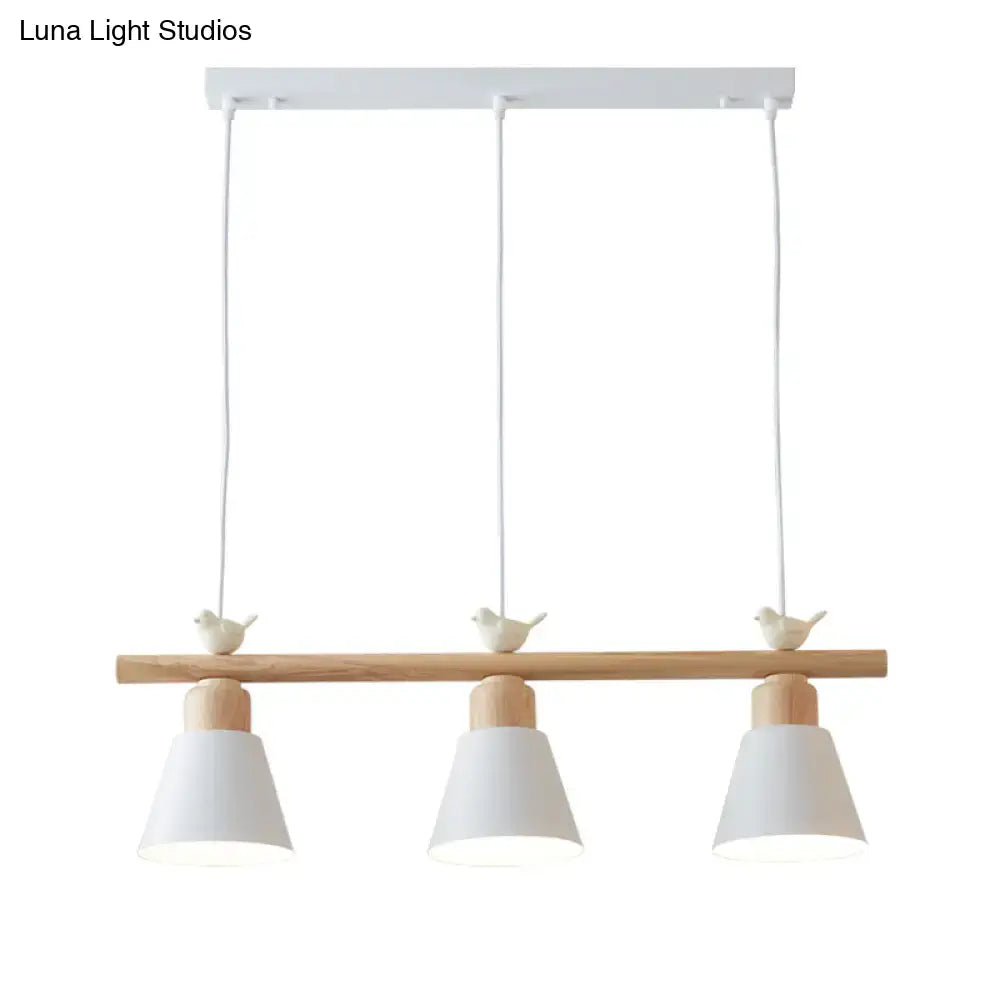 White metal hanging island light with three conical shades natural wood bar and bird decor for dining room