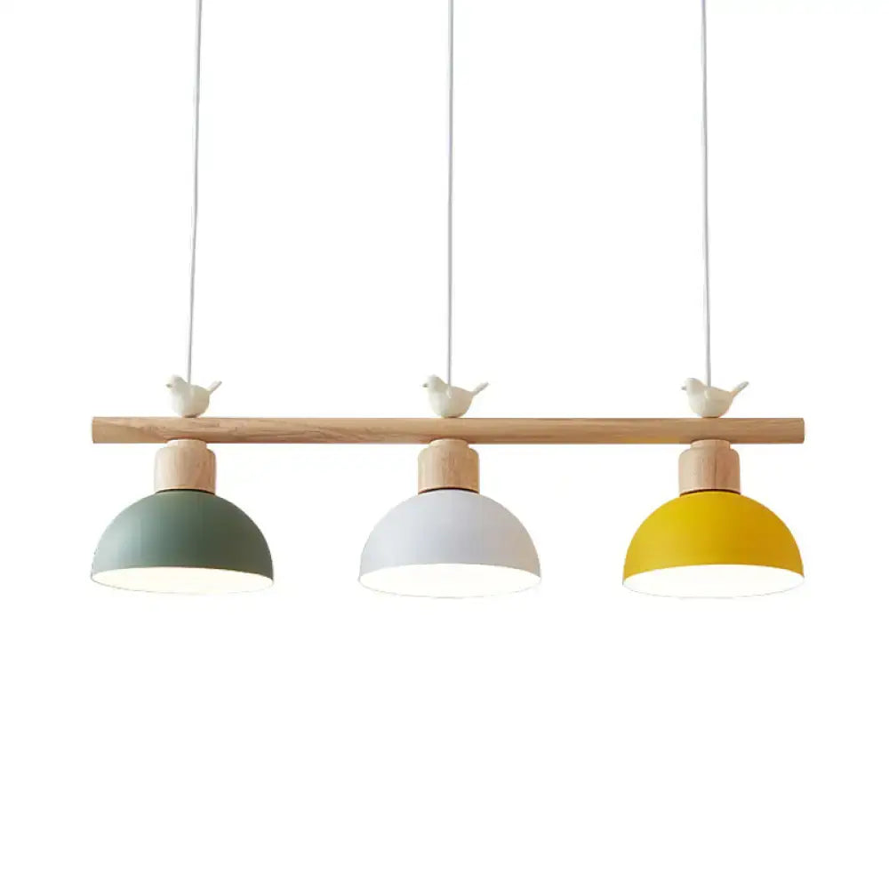 Decorbites nordic metal hanging island light with three dome shades in sage green white and yellow on wooden bar