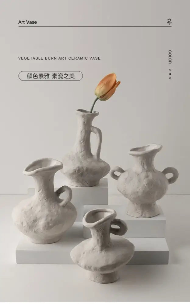 A collection of four off-white nordic style ceramic flower pots with textured handcrafted surfaces and unique handles