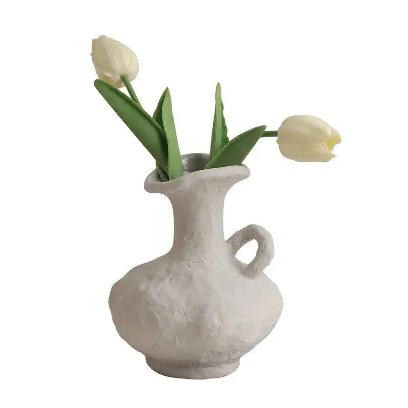 DecorBites™ nordic style ceramic flower pot in white with a handle holds two pale yellow tulips