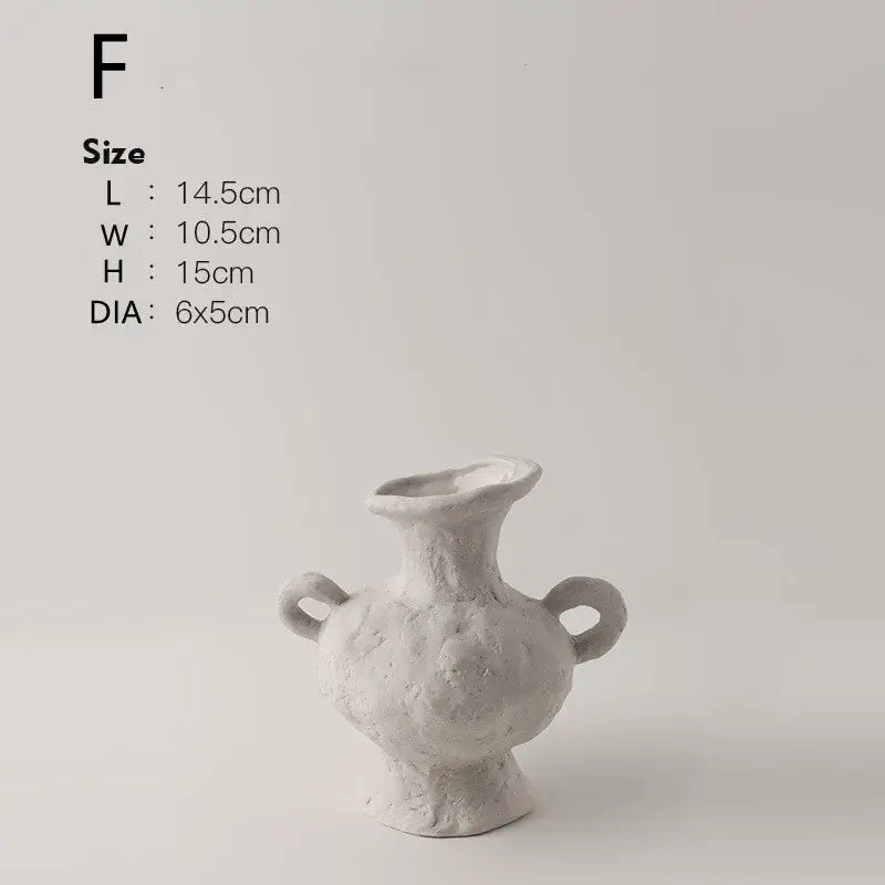 A textured white nordic style ceramic flower pot with two handles and a flared opening by decorbites