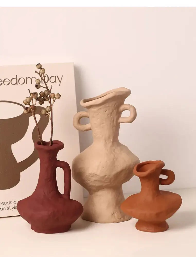 Three handcrafted nordic style ceramic flower pots in white with organic shapes and earthy tones from DecorBites™