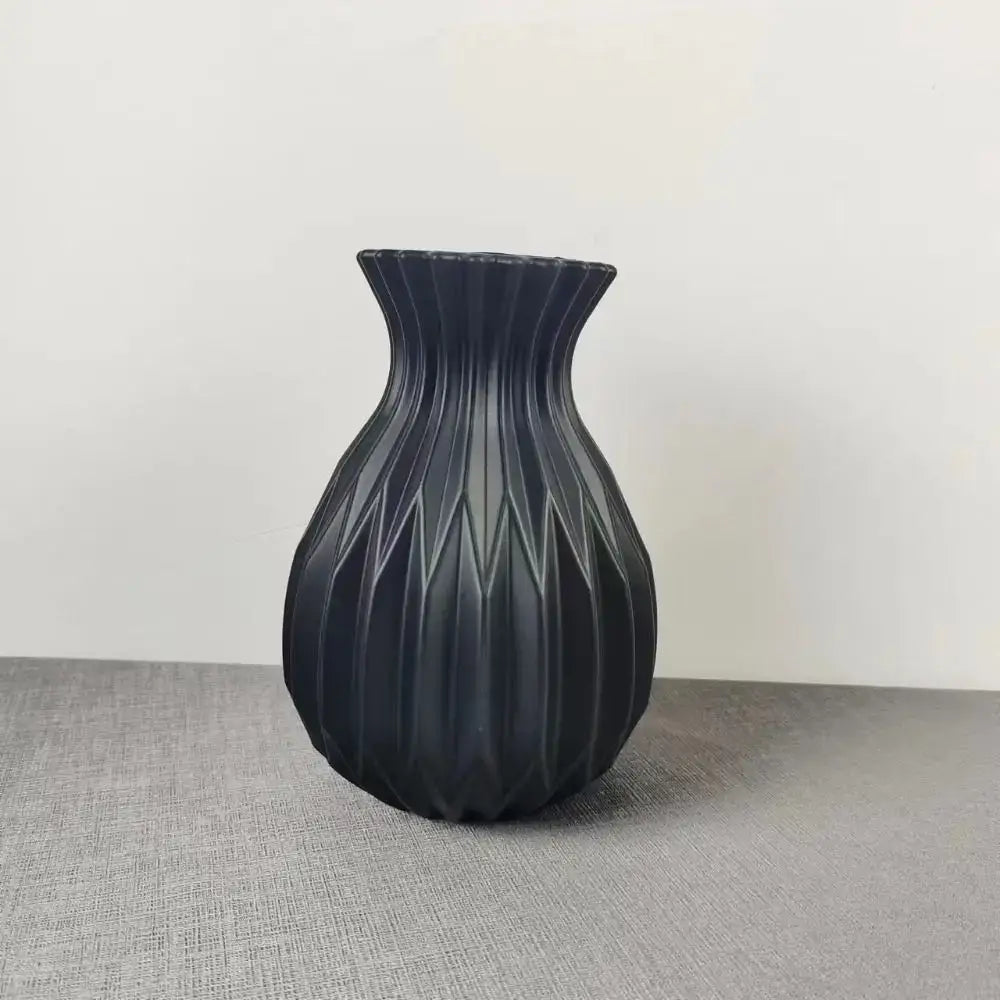 Black matte ceramic flower vase with geometric ribbed design from DecorBites Nordic style collection