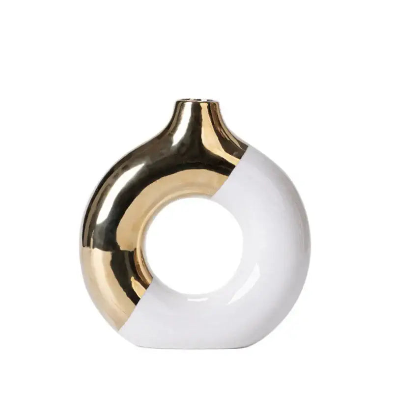 A sleek nordic style circle vase with glossy white ceramic and metallic gold finish for elegant flower arrangement