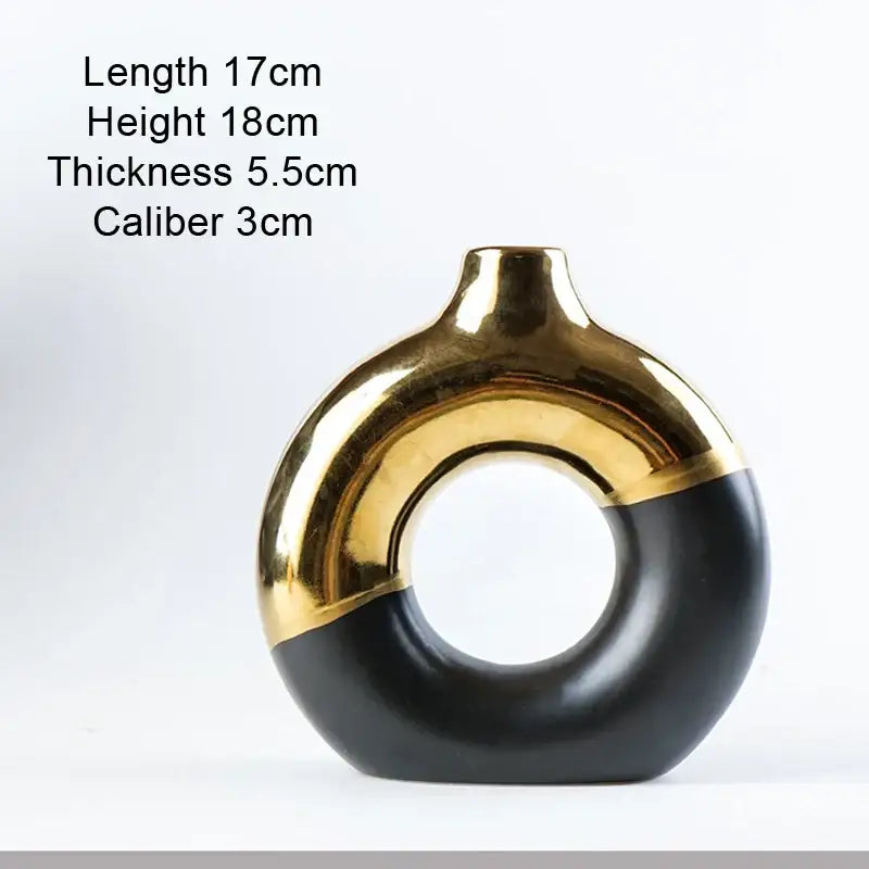A sleek black and gold ceramic nordic style circle vase with a modern ring-shaped design for flower arrangement