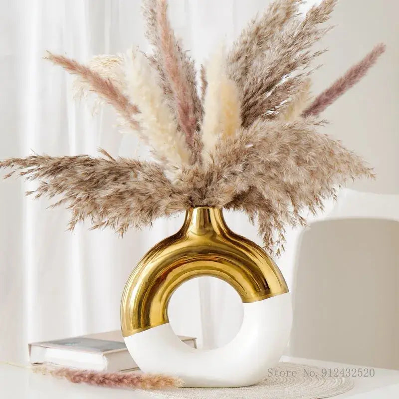 DecorBites™ nordic style circle vase in glossy gold and white ceramic holds beige and pink pampas grass arrangement
