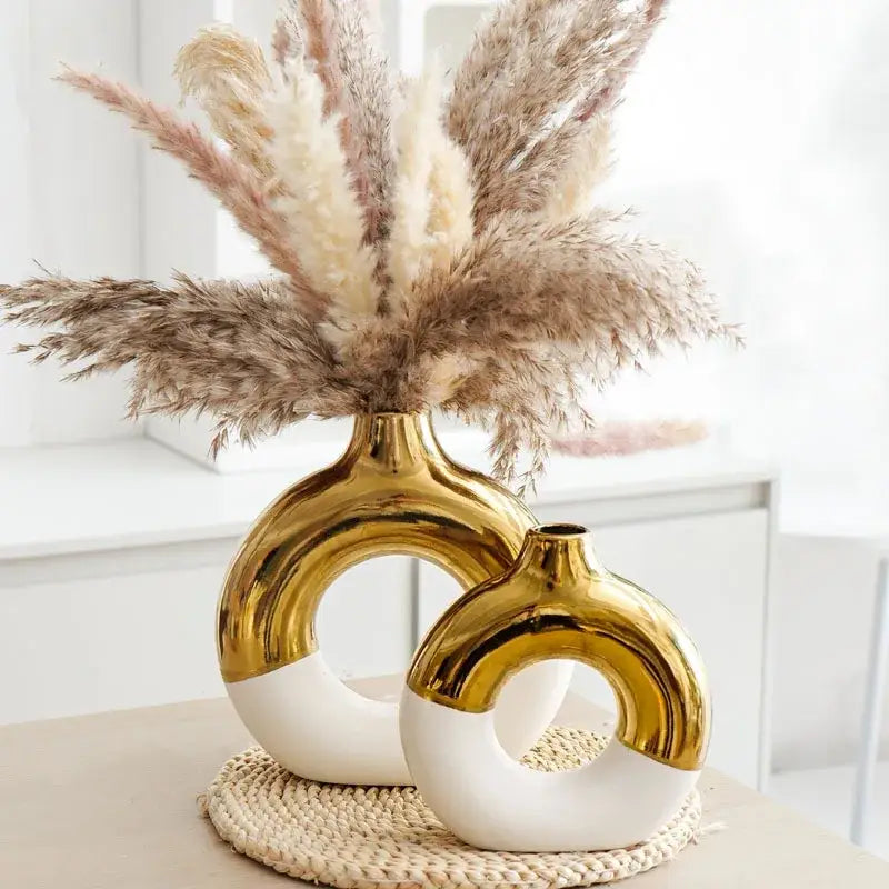 Two gold and white ceramic vases with a modern nordic style circle design for flower arrangement by DecorBites
