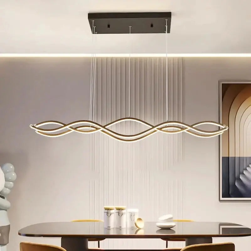Modern gold-toned led pendant light with wave-like design and minimalist mount for nordic style dining room decor