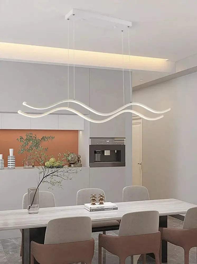 Modern white led pendant light with sleek wavy design for nordic style dining room by DecorBites™ above dining table