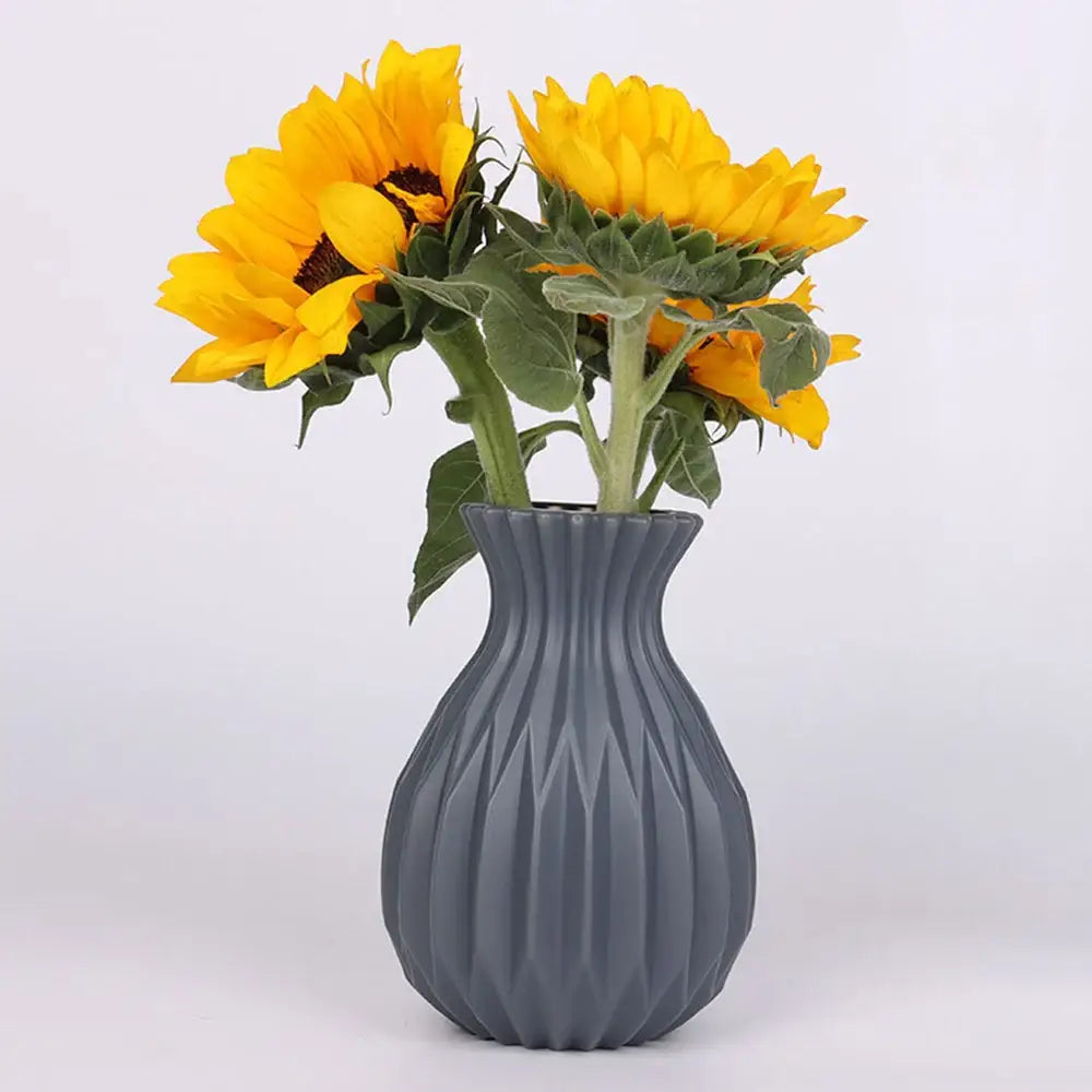 Gray geometric plastic flower vase by decorbites holding vibrant yellow sunflowers for home decor