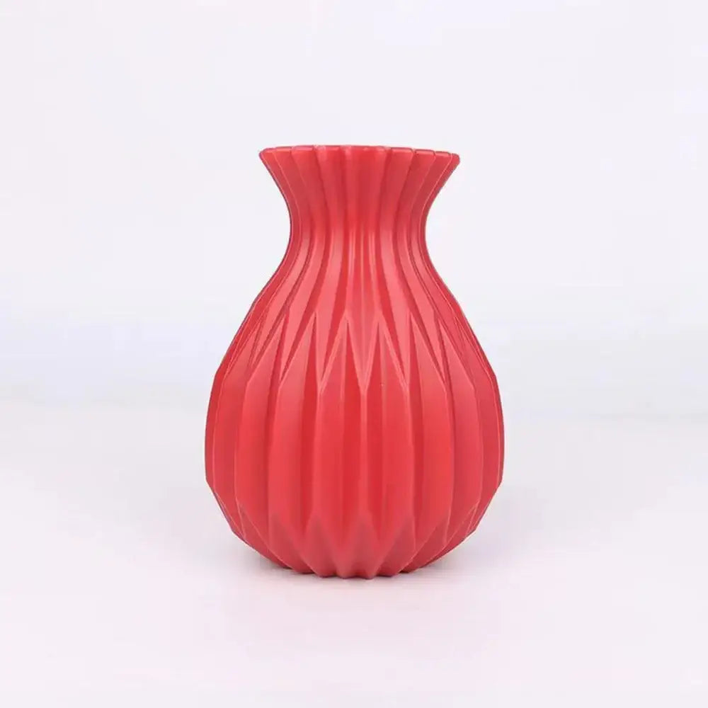 A vibrant red ribbed plastic flower vase with flared rim and geometric pattern for home decor by DecorBites™ Nordic style