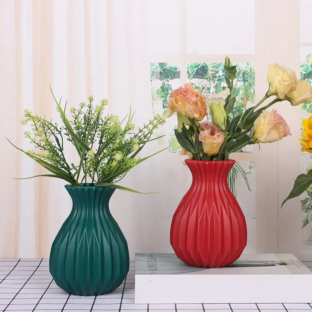 Vibrant red ribbed plastic flower vase by DecorBites™ holding peach and yellow flowers for home decor