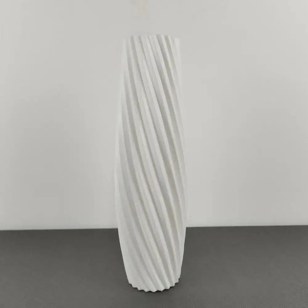 A tall white ceramic flower vase with a twisted ribbed design for plastic flower decor by DecorBites™ Nordic style