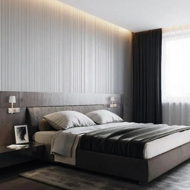 Modern gray upholstered bed with low-profile frame and dark wood headboard paired with nordic wall lights for bedroom