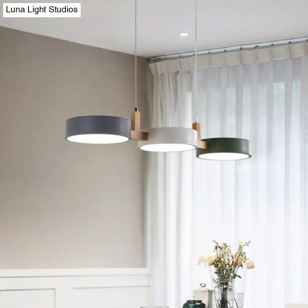 Modern three-light dining room pendant with matte gray, white, and dark green acrylic shades, bulb included, white warm light