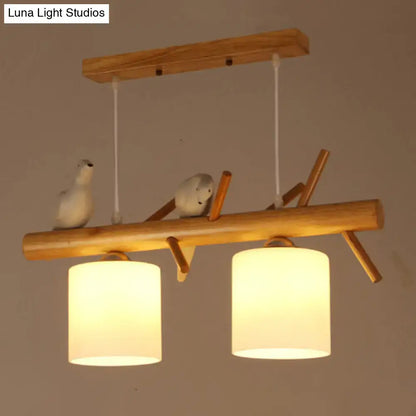Decorbites™ nordic wood pendant light features warm opal glass cylinder lampshades with resin bird decor accents