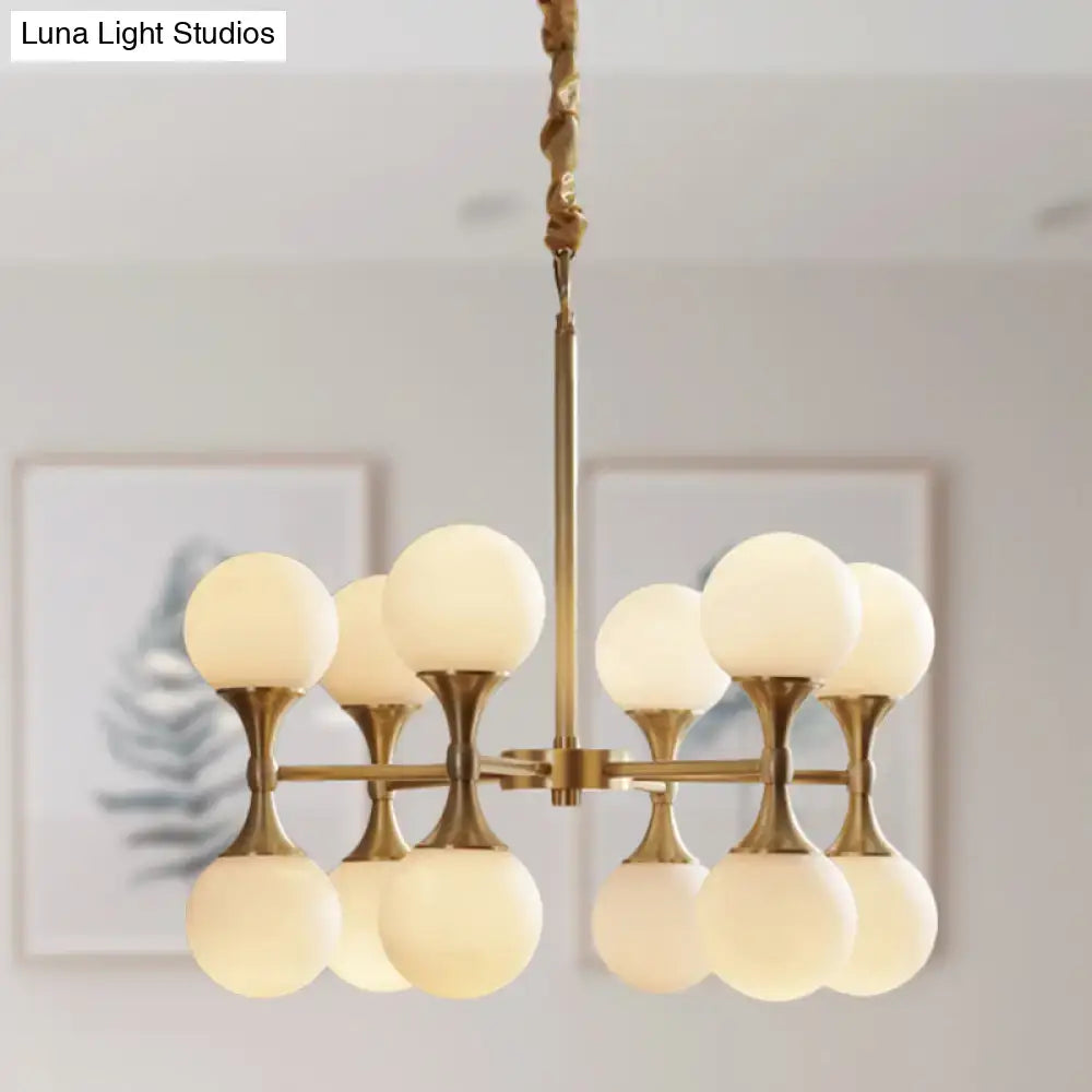 Brass-finished DecorBites™ opal glass chandelier light with eight frosted globe shades arranged in two tiers