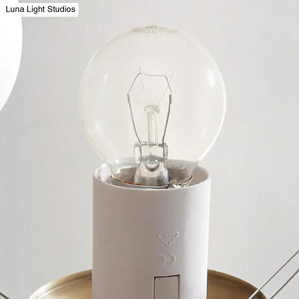 Clear glass globe light bulb with visible filament in white socket part of DecorBites opal glass chandelier light