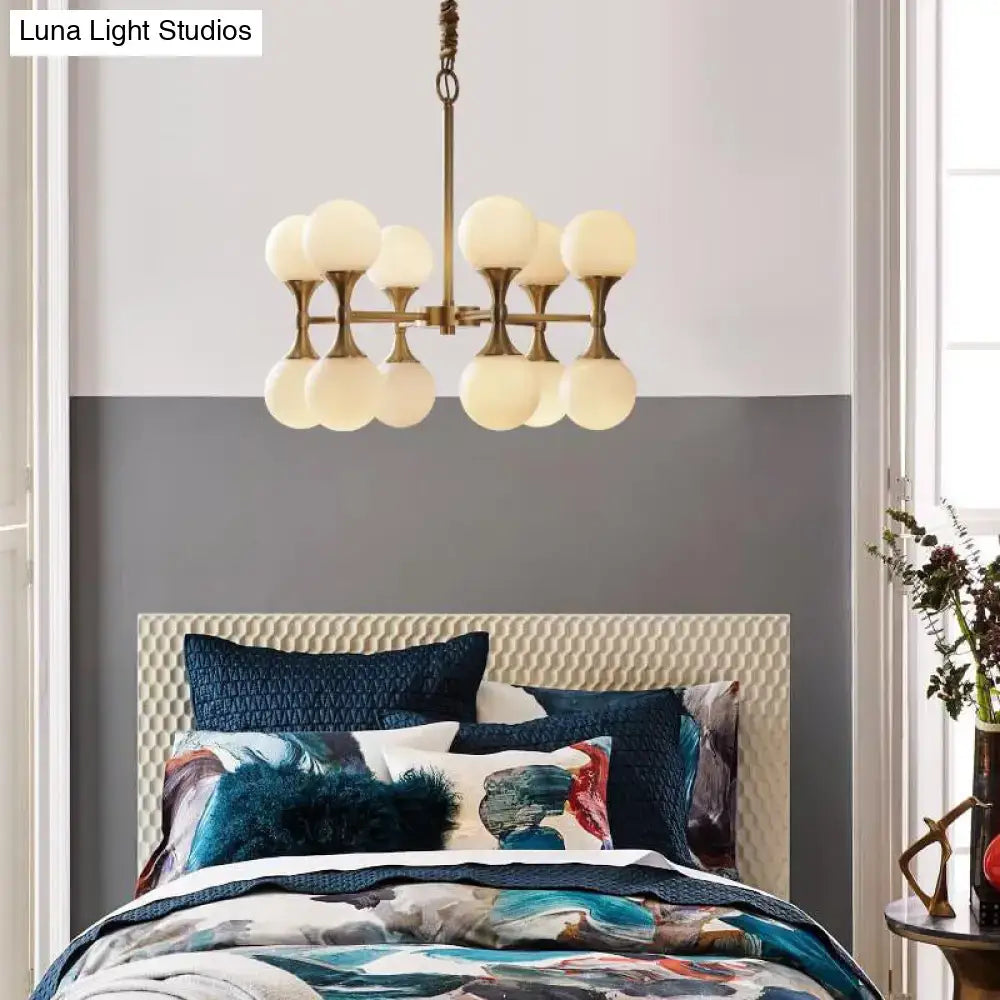 Decorbites opal glass chandelier light with 12 brass globe heads featuring frosted opal glass globes in brass finish