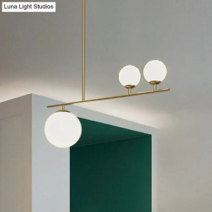 Modern brass pendant hanging lamp with three frosted opal glass globe shades for elegant island lighting