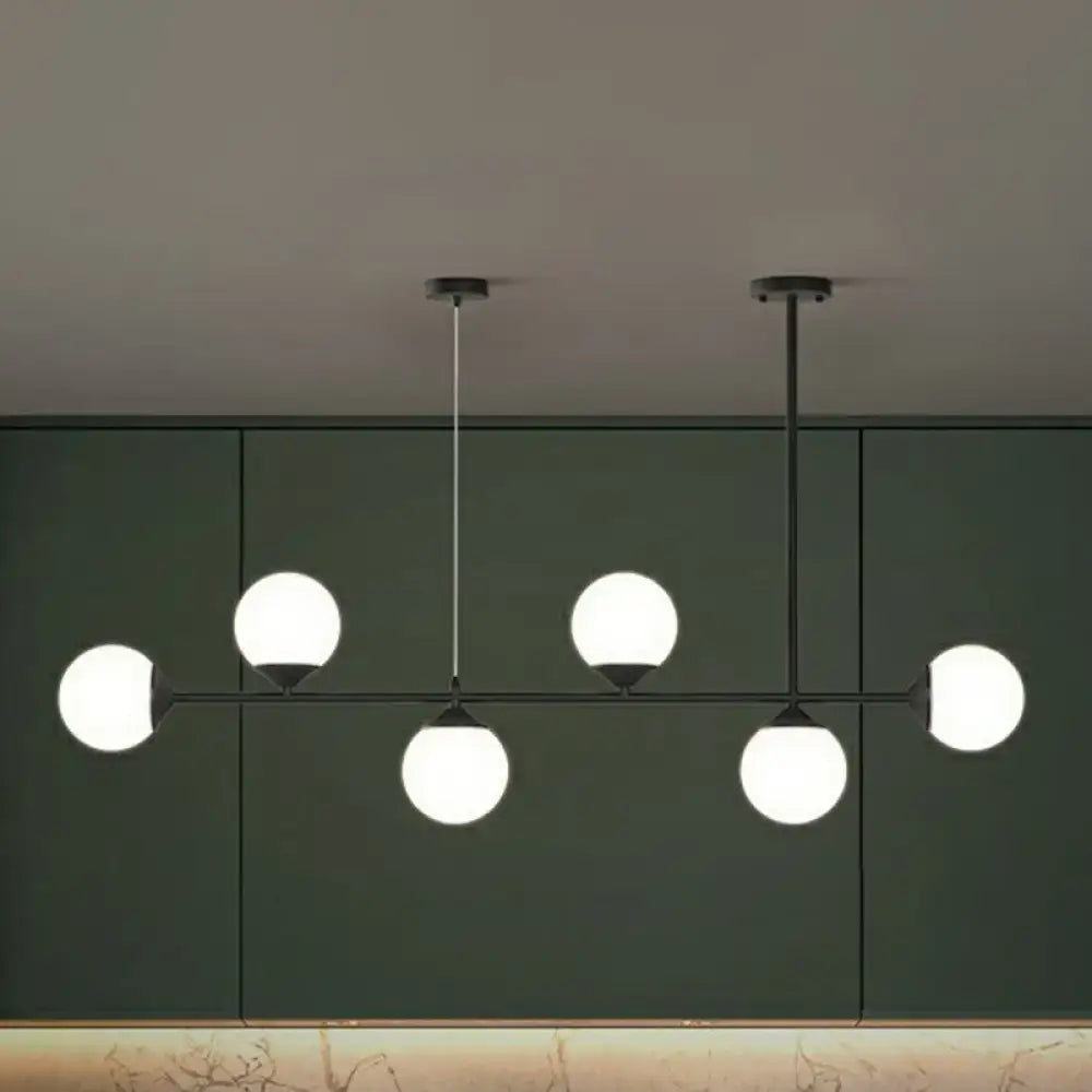 Modern black metal chandelier with five frosted opaline glass globe bulbs for minimalist dining room island lighting