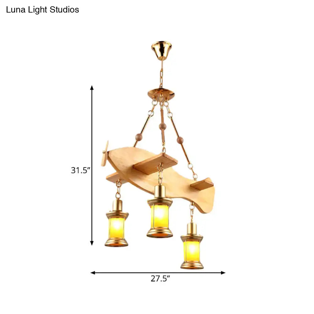 A golden airplane-shaped pendant light with wooden wings and brass lanterns featuring fish guitar design accents