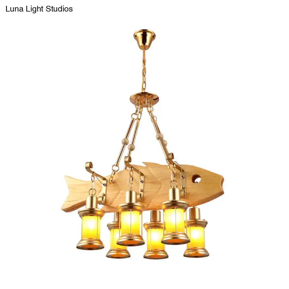 Golden fish guitar design pendant light with wooden body brass accents and five warm orange glass lanterns