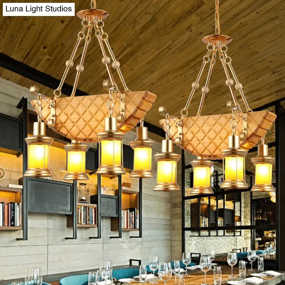 Gold-toned pendant light with woven basket shade and lantern bulbs featuring fish guitar design and orange glass accents