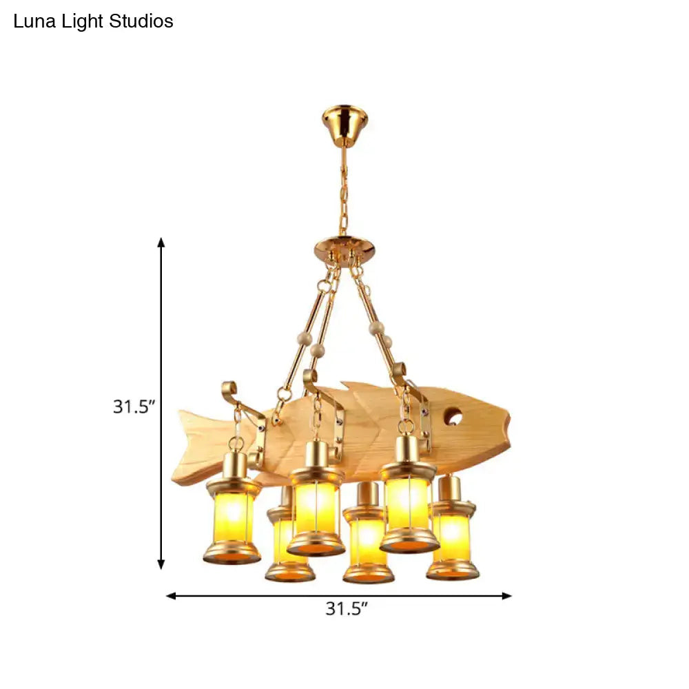 Golden fish guitar design pendant light with wooden body brass accents and five warm orange glass lanterns