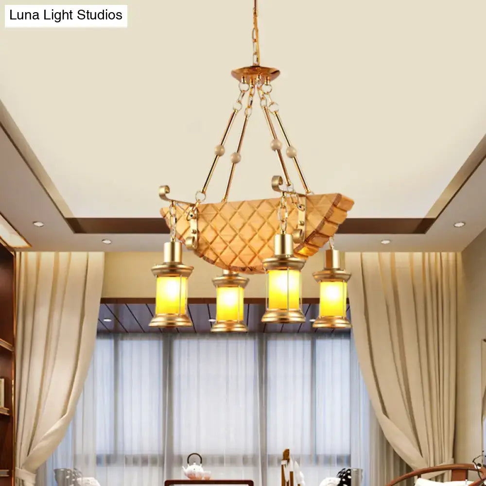 Gold-toned DecorBites™ pendant light with orange glass quilted shade and fish guitar design lantern fixtures