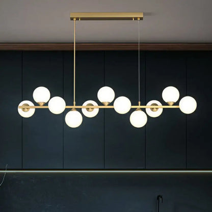 Gold-toned DecorBites™ 11-light island hanging light with white glass shade globes in a linear postmodern design