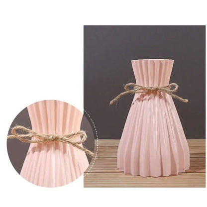 A blush pink pleated ceramic origami vase with rustic twine bow decorative for plastic flower vase display