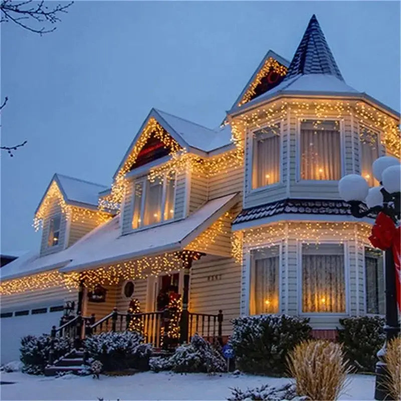 A cozy victorian house decorated with warm golden outdoor christmas waterfall curtain string lights 5m long