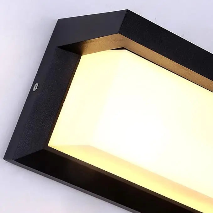 DecorBites™ outdoor motion activated led porch light with black rectangular design, warm yellow glow, and gold accent trim