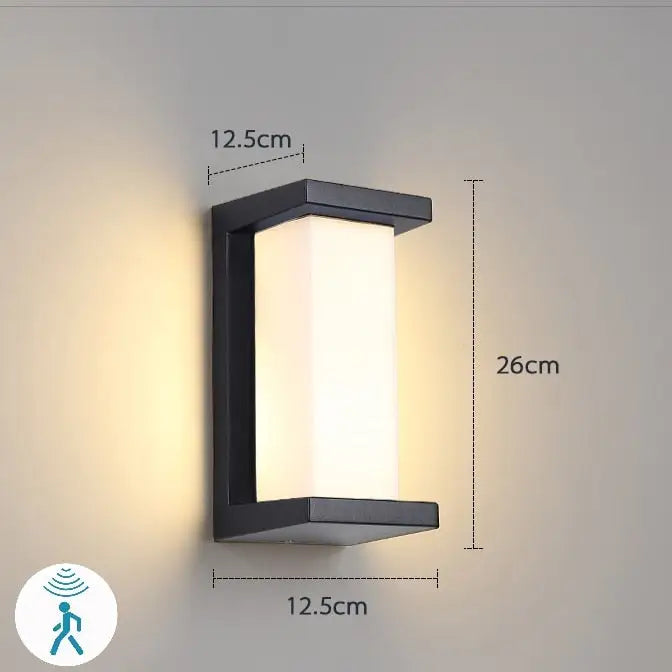 Black rectangular DecorBites™ led porch light with frosted glass panel emitting warm white illumination for outdoor use
