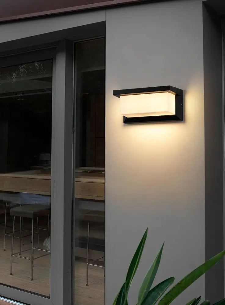 Modern black-framed DecorBites™ outdoor motion activated led porch light with warm diffused light fixture