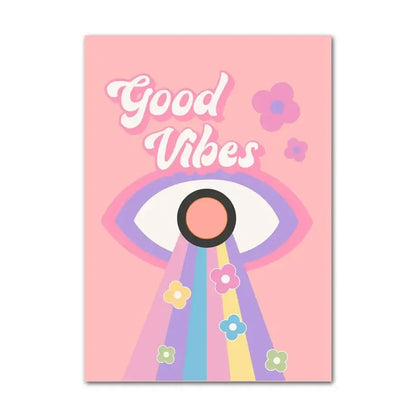 Pink rectangular canvas wall art by DecorBites featuring a smiley flower eye with rainbow rays and good vibes text in white cursive