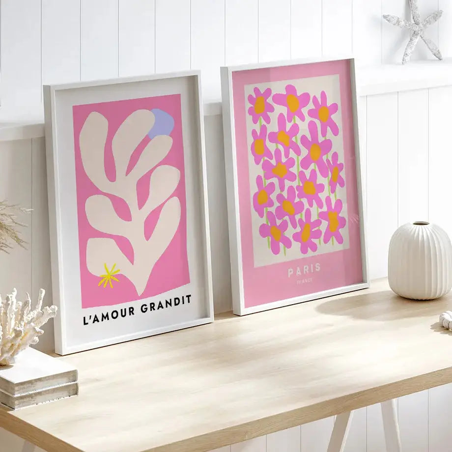Two framed decorbites™ gallery wall art prints with pink backgrounds featuring stylized white coral and vibrant flowers pink angel number poster