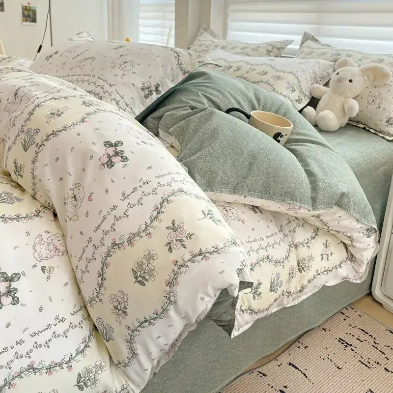 Cream-colored decorbites™ queen size bedding set with pink floral and bunny patterns in soft gray pink and green hues