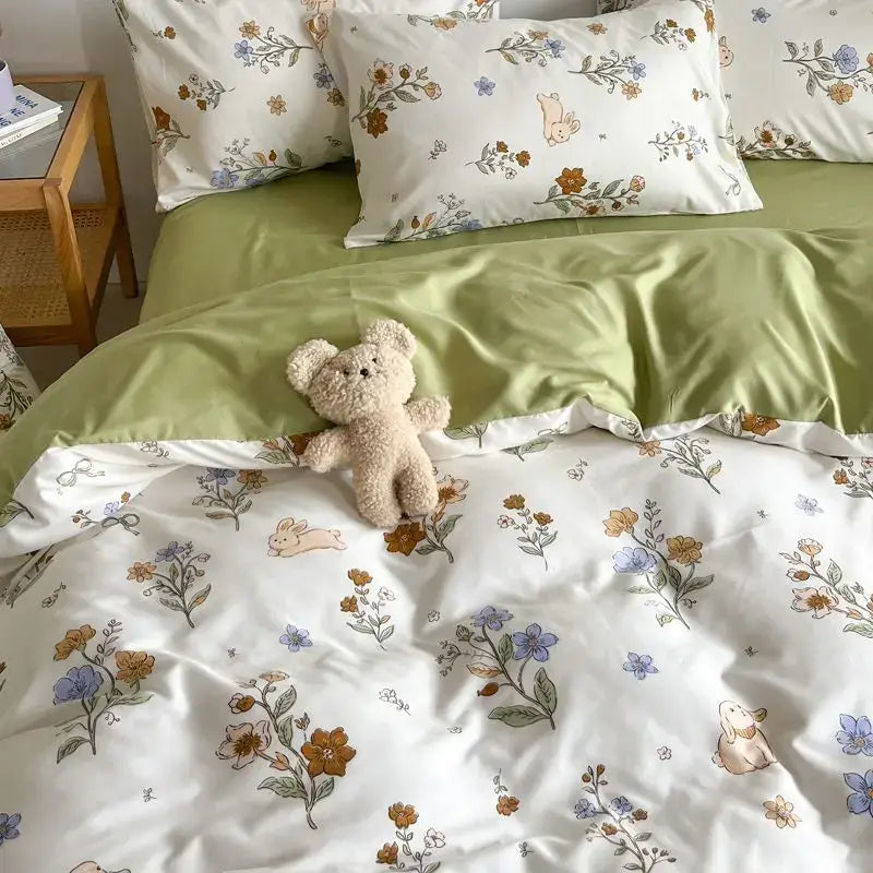 Fluffy beige teddy bear plush toy placed on a decorbites™ pink floral bedding set queen size with pink floral design